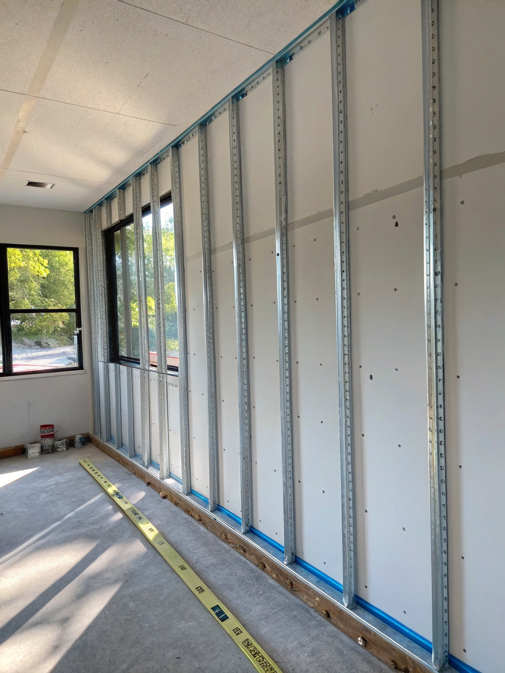 Contrasting two-tone steel wainscoting on post frame building exterior